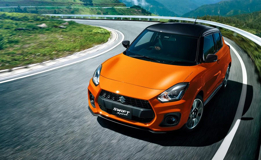 Orange Suzuki Sport driving on a track