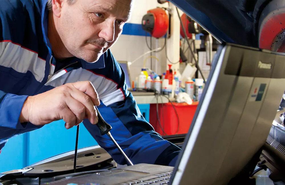 Suzuki technician working on an engine