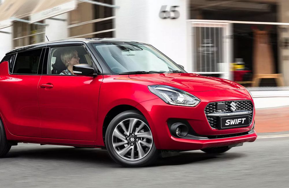 Red Swift driving on a city street